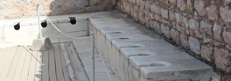 There is a rope in front of the Ephesus Latrine's seat and sitting on them is not allowed