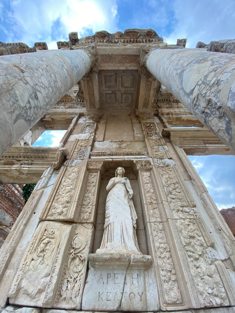 statue of a woman in concrete wall