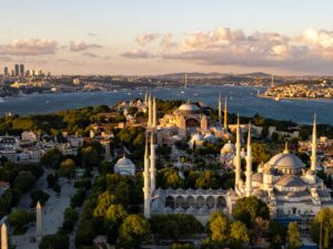Aerial view of Istanbul at sunset with the Blue Mosque and Hagia Sophia on the old city peninsula, the Bosphorus and the far shore beyond