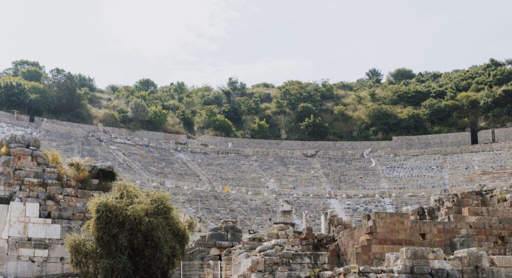 10 Most Important Cornerstones in Ephesus History 1 Curved rows of seats of the Great Theater of Ephesus on the hillside, a theater whose first phase belongs to the Hellenistic period